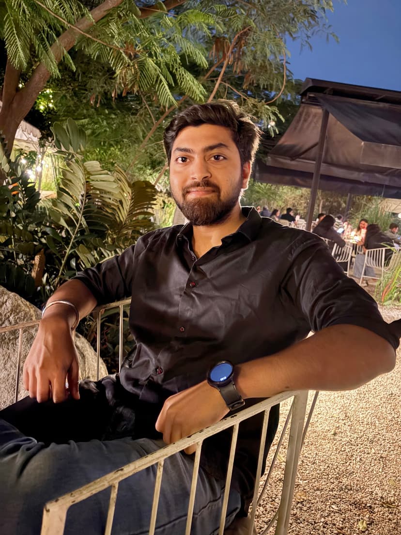 Sujay sitting on a open sky resturant at night with candle light style theme